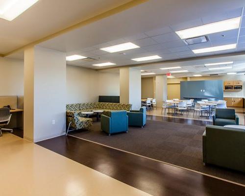Photo of the break room at California Proton Cancer Therapy Center. Dining tables, couches, and extra comfy seating available.